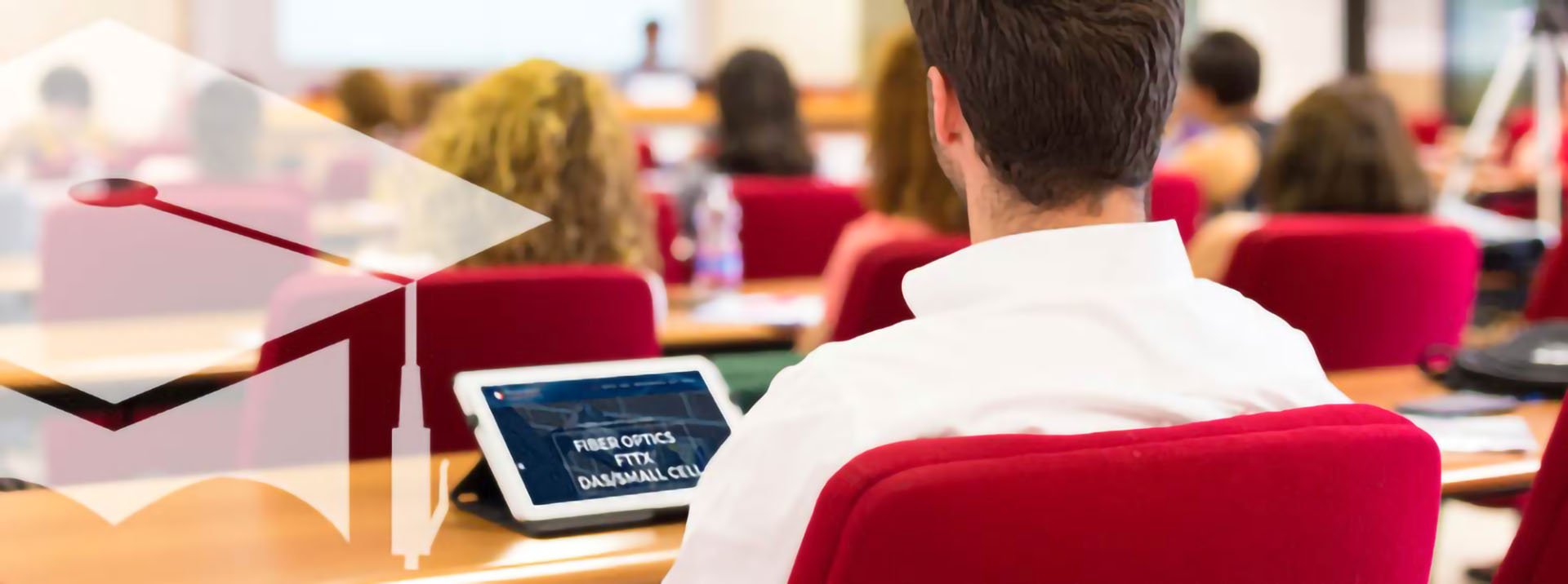 Student in a white shirt sitting in front of a computer in a fiber optic training session